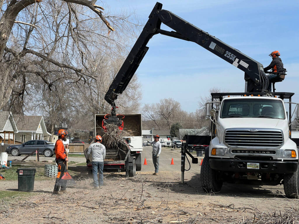 A crew using heavy machinery to clear a street